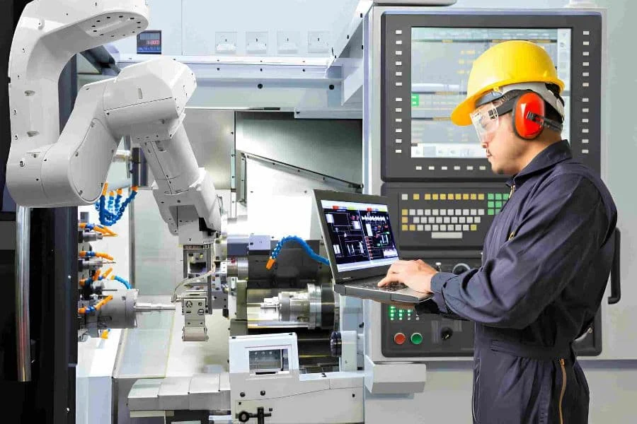 6.4 Robotic Engineer Using Laptop Computer For Maintenance Automatic Robotic Arm With Cnc Machine In Smart Factory. Industry 4.0 Concept